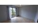 Bedroom with tile flooring, neutral paint, and sliding glass doors leading to an outdoor space at 1401 43Rd S St, St Petersburg, FL 33711