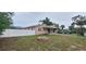 Quaint home featuring a fenced yard, small fire pit, and covered parking at 1401 43Rd S St, St Petersburg, FL 33711