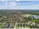 Community featuring houses, green spaces, a lake, and schools visible from above at 14110 Barrington Stowers Dr, Lithia, FL 33547