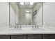 Bathroom featuring double sink vanity, modern fixtures, and neutral walls at 14110 Barrington Stowers Dr, Lithia, FL 33547