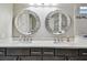Elegant bathroom with double sink vanity, designer mirrors, and quartz countertops at 14110 Barrington Stowers Dr, Lithia, FL 33547