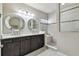 Bathroom featuring double sinks, granite countertops, a frameless shower with a built in bench at 14110 Barrington Stowers Dr, Lithia, FL 33547