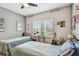 Bedroom featuring neutral walls, two beds, a window, and a ceiling fan at 14110 Barrington Stowers Dr, Lithia, FL 33547