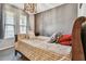 Cozy bedroom showcasing a striped bed, decorative pillows, and natural light at 14110 Barrington Stowers Dr, Lithia, FL 33547