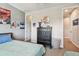 View of a nicely decorated bedroom with a neatly made bed, chest of drawers, and carpeted floor at 14110 Barrington Stowers Dr, Lithia, FL 33547