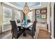 Elegant dining room featuring a large crystal chandelier, stylish decor, and ample natural light at 14110 Barrington Stowers Dr, Lithia, FL 33547