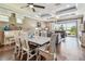 Bright dining area with an open floor plan featuring an elegant chandelier and backyard views at 14110 Barrington Stowers Dr, Lithia, FL 33547