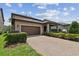 Attractive home with a two-car garage, well-maintained lawn, and a covered patio area at 14110 Barrington Stowers Dr, Lithia, FL 33547