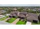 Street view of three homes with attached garages, driveways and green lawns at 14110 Barrington Stowers Dr, Lithia, FL 33547