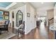 The elegant foyer offers hardwood floors, decorative mirror and flows into the dining and kitchen area at 14110 Barrington Stowers Dr, Lithia, FL 33547