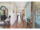 The bright foyer boasts hardwood floors, a decorative mirror, and an open view into the home at 14110 Barrington Stowers Dr, Lithia, FL 33547