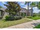Inviting two-story home with lush landscaping, mature trees, and a welcoming front lawn at 14110 Barrington Stowers Dr, Lithia, FL 33547