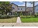 Charming two-story home with a well-kept lawn, neatly trimmed bushes, and a stone-accented facade at 14110 Barrington Stowers Dr, Lithia, FL 33547