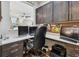 View of the home office featuring dual monitors, custom cabinets and desk space at 14110 Barrington Stowers Dr, Lithia, FL 33547