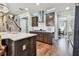 Open kitchen with dark wood cabinets, quartz countertops, and stainless steel appliances at 14110 Barrington Stowers Dr, Lithia, FL 33547