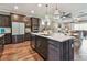 Modern kitchen featuring a large island, stainless steel appliances, and an open floor plan at 14110 Barrington Stowers Dr, Lithia, FL 33547