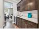 Kitchen counter with built-in wine rack, stainless steel beverage cooler, and quartz countertops at 14110 Barrington Stowers Dr, Lithia, FL 33547