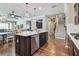 Kitchen with dark wood island, stainless steel appliances, and open layout to dining and living areas at 14110 Barrington Stowers Dr, Lithia, FL 33547