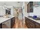 Bright kitchen with stainless steel appliances, quartz countertops, and dark wood cabinets at 14110 Barrington Stowers Dr, Lithia, FL 33547