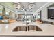 Gourmet kitchen with large island and stainless steel sink offers sleek design and functionality at 14110 Barrington Stowers Dr, Lithia, FL 33547