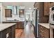 Kitchen featuring dark wood cabinets, quartz countertops, and stainless steel appliances at 14110 Barrington Stowers Dr, Lithia, FL 33547