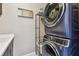 Modern laundry room featuring stacked washer and dryer and a sink with a countertop at 14110 Barrington Stowers Dr, Lithia, FL 33547