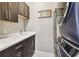 Modern laundry room featuring stacked washer and dryer and a sink with a countertop at 14110 Barrington Stowers Dr, Lithia, FL 33547