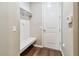 Mudroom with convenient built-in bench, storage, hooks, and access to the garage at 14110 Barrington Stowers Dr, Lithia, FL 33547