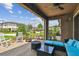 Covered patio, with fire pit, comfortable seating, and a landscaped backyard at 14110 Barrington Stowers Dr, Lithia, FL 33547