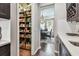 Walk-in pantry with organized shelving and access to the kitchen and dining area at 14110 Barrington Stowers Dr, Lithia, FL 33547