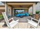 Inviting covered patio with outdoor seating, a fire pit, and a built-in grill area for entertaining at 14110 Barrington Stowers Dr, Lithia, FL 33547