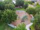 Aerial view of playground with play equipment and seating surrounded by mature shade trees at 14110 Barrington Stowers Dr, Lithia, FL 33547