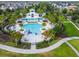 Aerial view of a community pool area with a splash pad, swimming pool, and plenty of lounge seating at 14110 Barrington Stowers Dr, Lithia, FL 33547