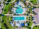 Overhead shot of community pools with large pool, splash area, sun loungers, and well-maintained landscaping at 14110 Barrington Stowers Dr, Lithia, FL 33547
