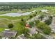Scenic aerial view of the neighborhood showcasing the homes, green spaces, and a lake at 1508 Ingram Dr # 20, Sun City Center, FL 33573