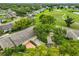 Expansive aerial view of a residential community with lush green landscapes and golf course, nestled among mature trees at 1508 Ingram Dr # 20, Sun City Center, FL 33573