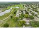 Wide aerial perspective of the community with ponds, golf course, and tree-lined streets at 1508 Ingram Dr # 20, Sun City Center, FL 33573