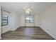 Empty bedroom featuring wood floors, neutral walls, a ceiling fan and two windows at 1508 Ingram Dr # 20, Sun City Center, FL 33573