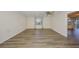 Open bedroom featuring hardwood floors, a window offering natural light, and an airy atmosphere at 1508 Ingram Dr # 20, Sun City Center, FL 33573