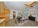 Dining room area showcasing wood floors, modern table set, and view into the kitchen at 1508 Ingram Dr # 20, Sun City Center, FL 33573