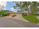 Charming exterior showcasing the attached two-car garage and meticulously maintained landscaping with mature trees at 1508 Ingram Dr # 20, Sun City Center, FL 33573