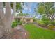 Attractive front exterior with lush landscaping, a well-maintained lawn, and mature trees in a tranquil setting at 1508 Ingram Dr # 20, Sun City Center, FL 33573