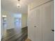 Hallway featuring hardwood floors, white doors, and neutral decor at 1508 Ingram Dr # 20, Sun City Center, FL 33573