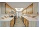 Well-lit kitchen featuring stainless steel appliances, tile countertops, and ample cabinet storage at 1508 Ingram Dr # 20, Sun City Center, FL 33573
