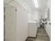 Functional laundry room with washer, dryer, ample storage cabinets, and wire shelving at 1508 Ingram Dr # 20, Sun City Center, FL 33573