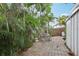 A private brick paver backyard patio area surrounded by lush landscaping and a wood fence at 1525 38Th N Ave, St Petersburg, FL 33704