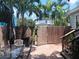 Private backyard featuring a brick patio, wooden fence, and lush tropical landscaping at 1525 38Th N Ave, St Petersburg, FL 33704