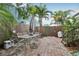 A private brick paver backyard patio area surrounded by lush landscaping and a wood fence at 1525 38Th N Ave, St Petersburg, FL 33704
