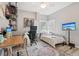 Well lit bedroom with a workstation, daybed, TV and decoratively adorned with shelves at 1525 38Th N Ave, St Petersburg, FL 33704