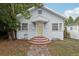 Charming single-story home with a welcoming brick walkway and light-blue painted siding at 1525 38Th N Ave, St Petersburg, FL 33704